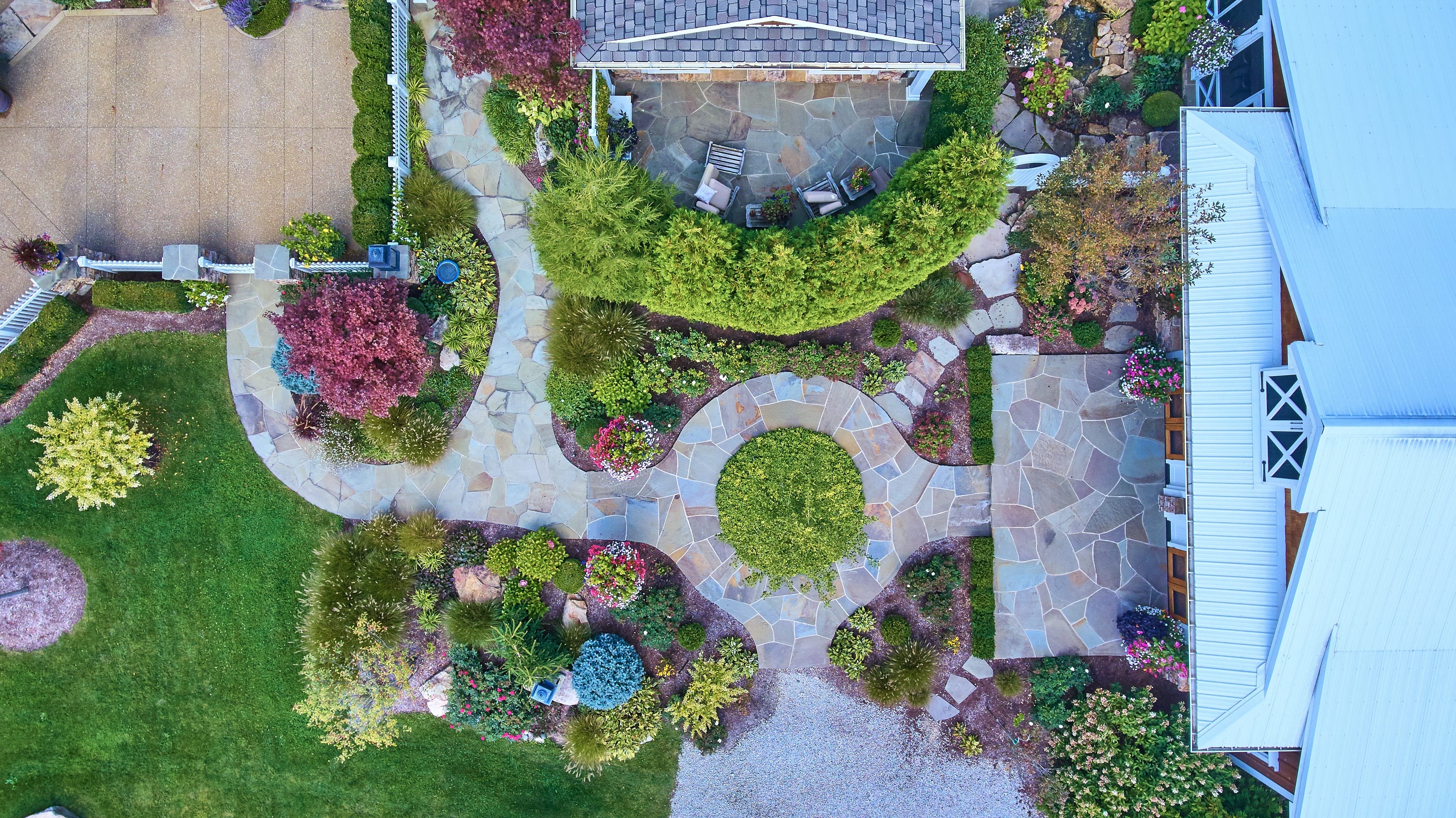 aerial,view,of,lush,residential,garden,with,stone,patio,and