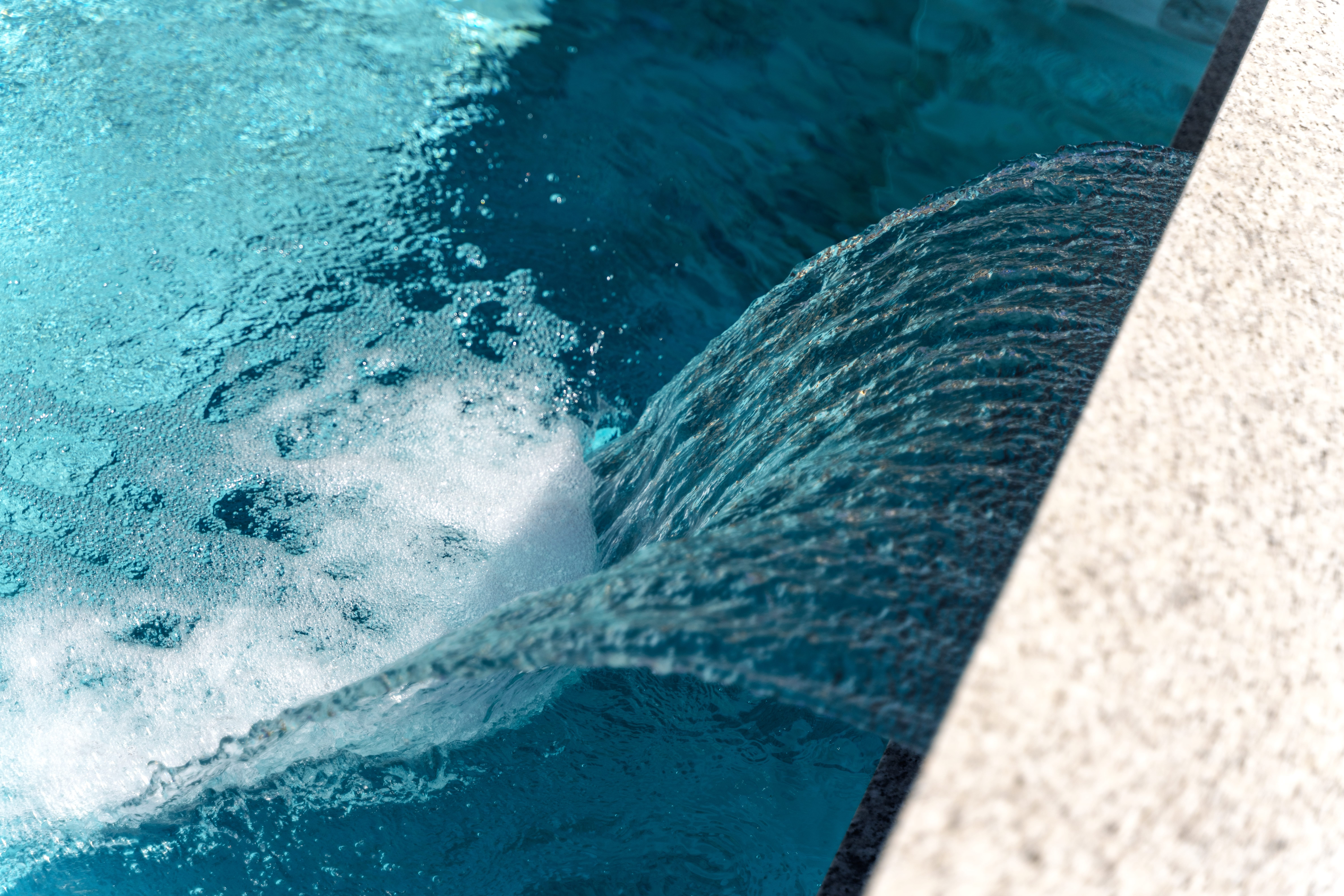swimming,pool,at,sunny,day,with,waterfall,closeup